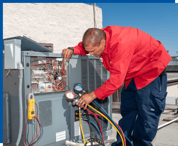 A man working on an air conditioner unit.